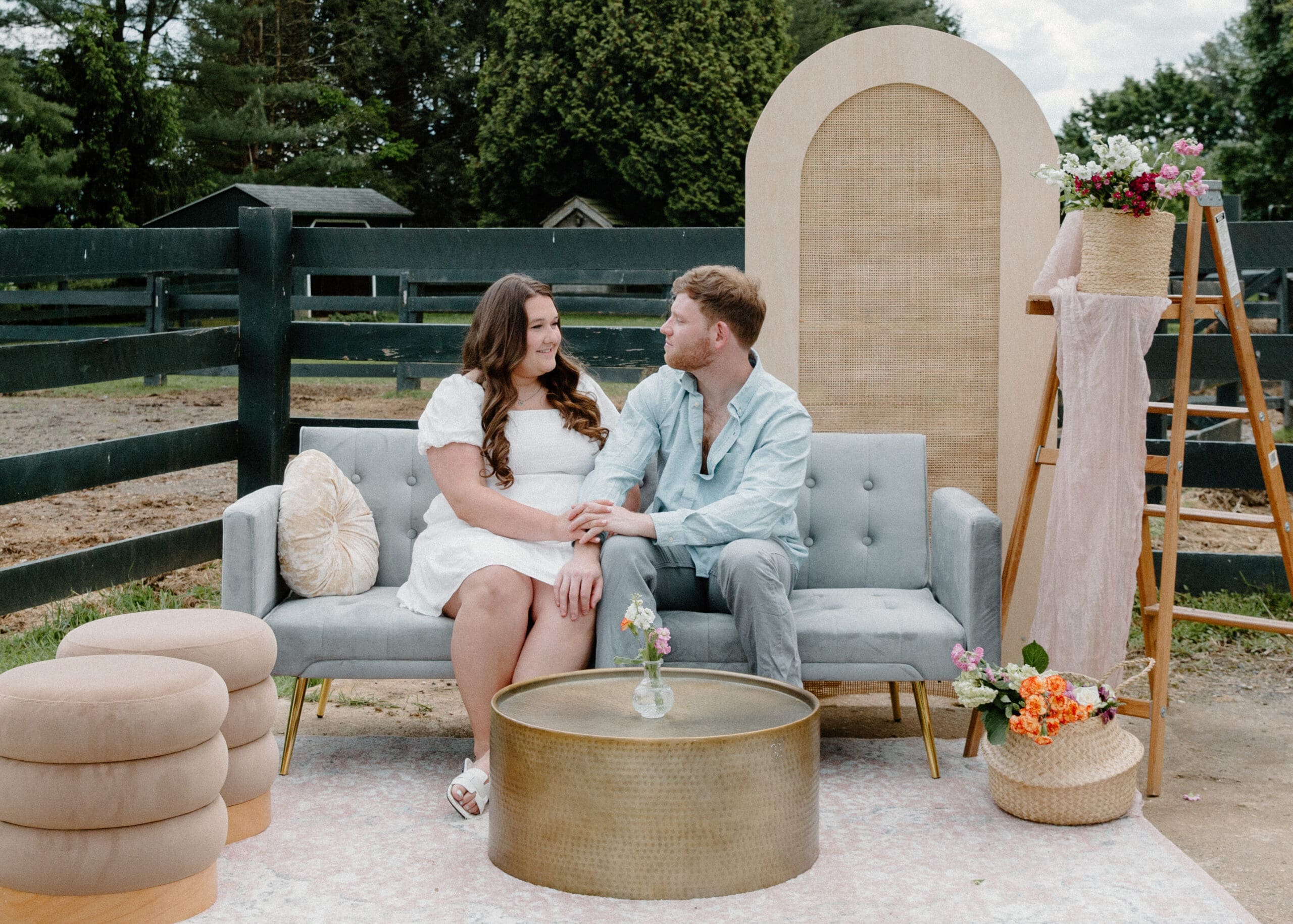 Rentals + Decor Category Vendor Boho and Magnolia couple sitting on a gray velvet couch in a seating area