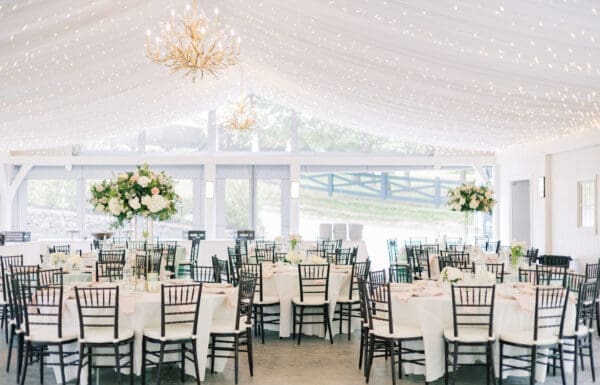 Venue Category Vendor Gallery Moonstone Manor a white tent with tables and chairs