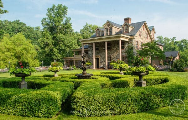 Venue Category Vendor Gallery Moonstone Manor a large house with a fountain in front of it