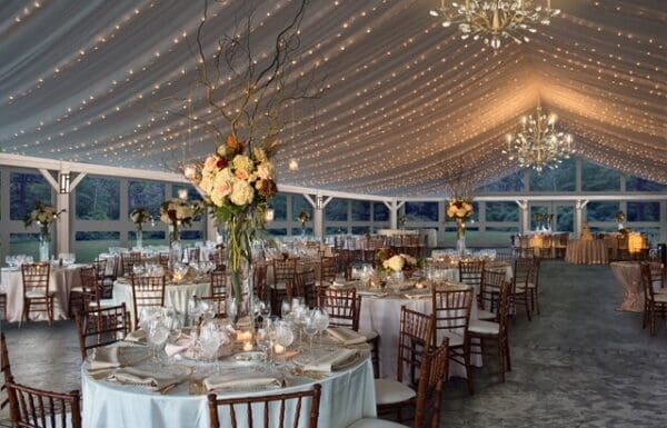 Venue Category Vendor Gallery Moonstone Manor a large tent with tables and chairs