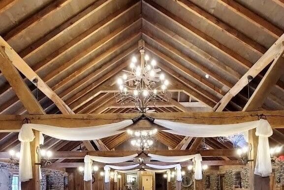 Room Facilites Moonstone Manor a large room with a chandelier and ceiling fan Gallery 5